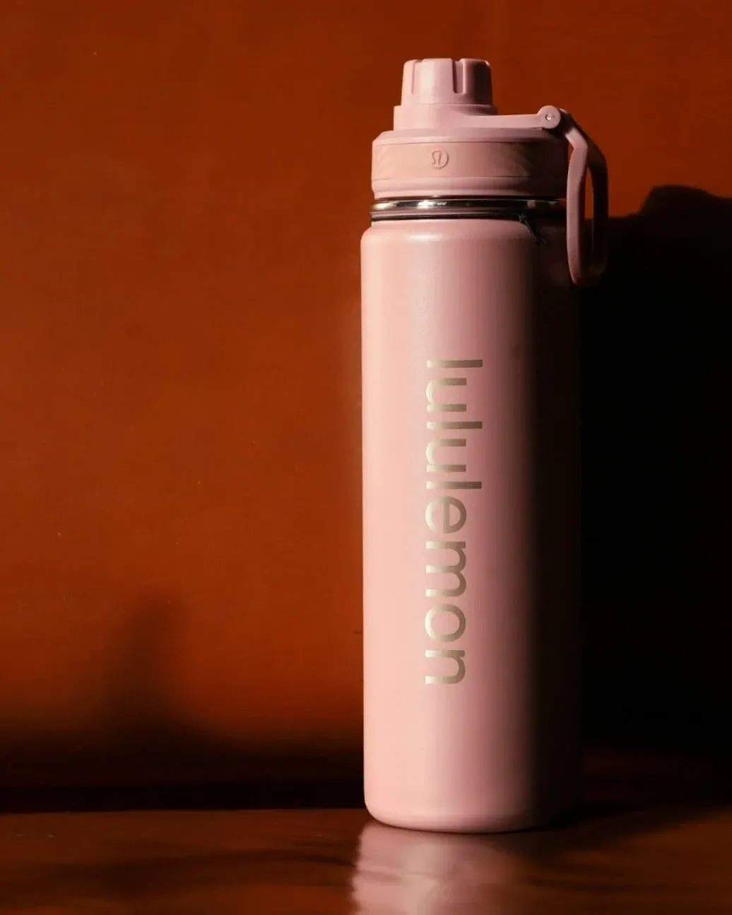 Lululemon Pink mist insulated stainless steel water bottle, 710 ml, front view with screw lid