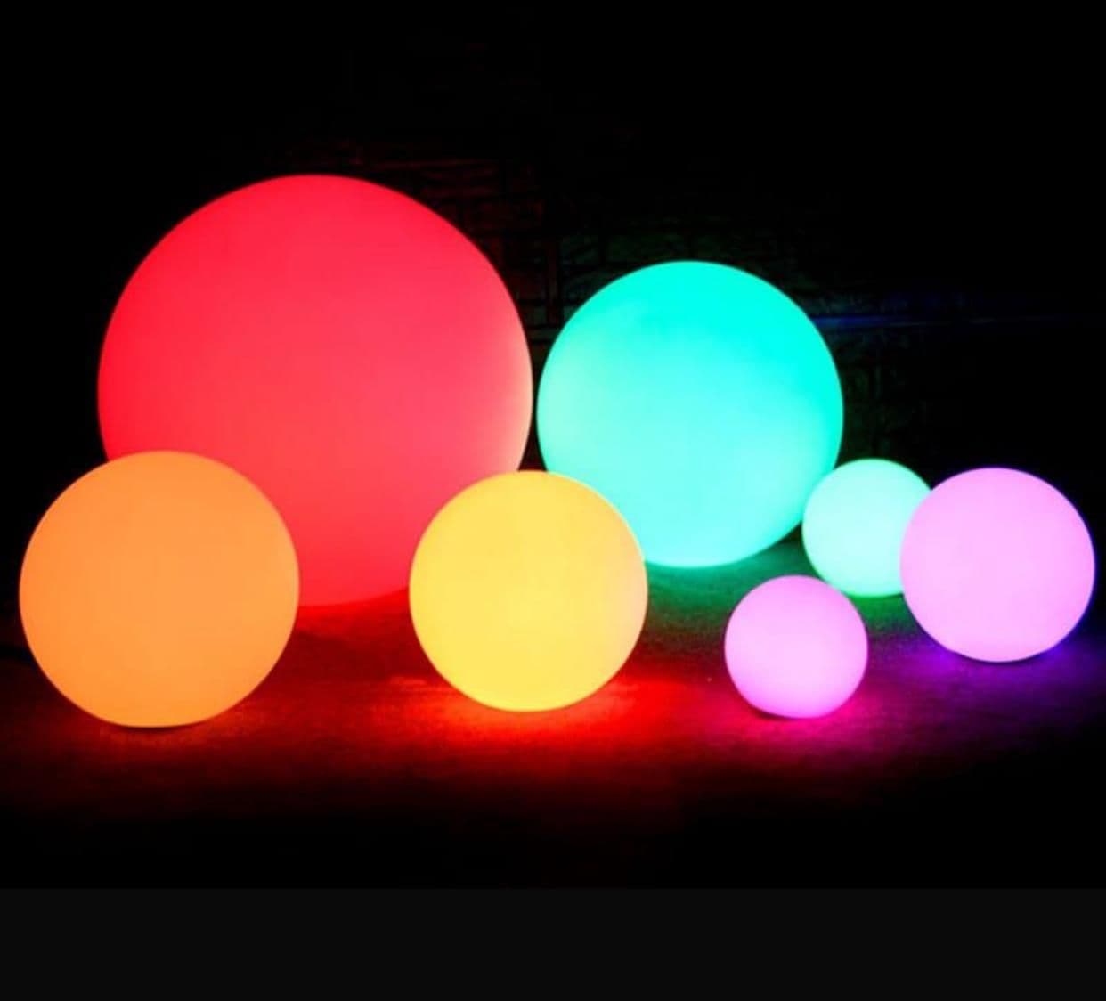 RGB LED ball lights in multiple sizes and colours glowing on a dark background