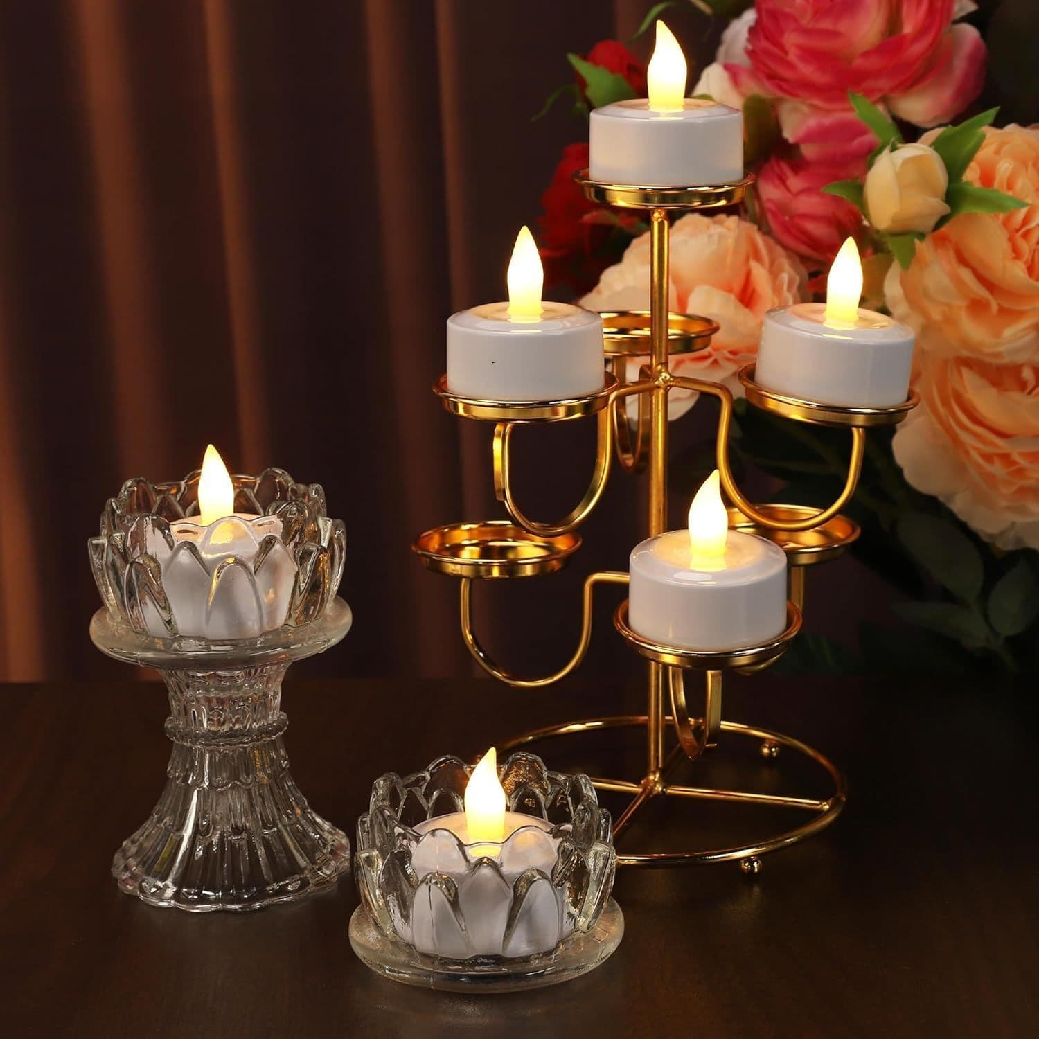 LED candles in glass holders styled with flowers on a table setting