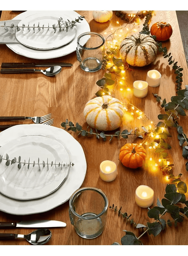 Flameless LED candles styled on a festive table setting with gold accents