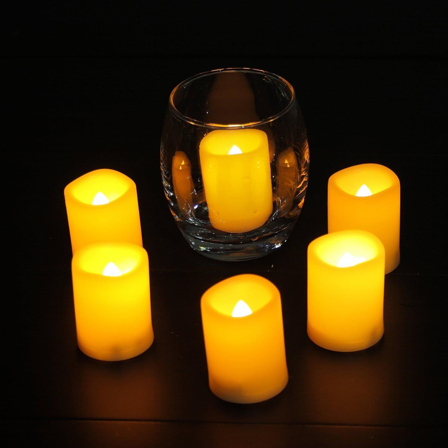LED candles lit warm inside glass holders