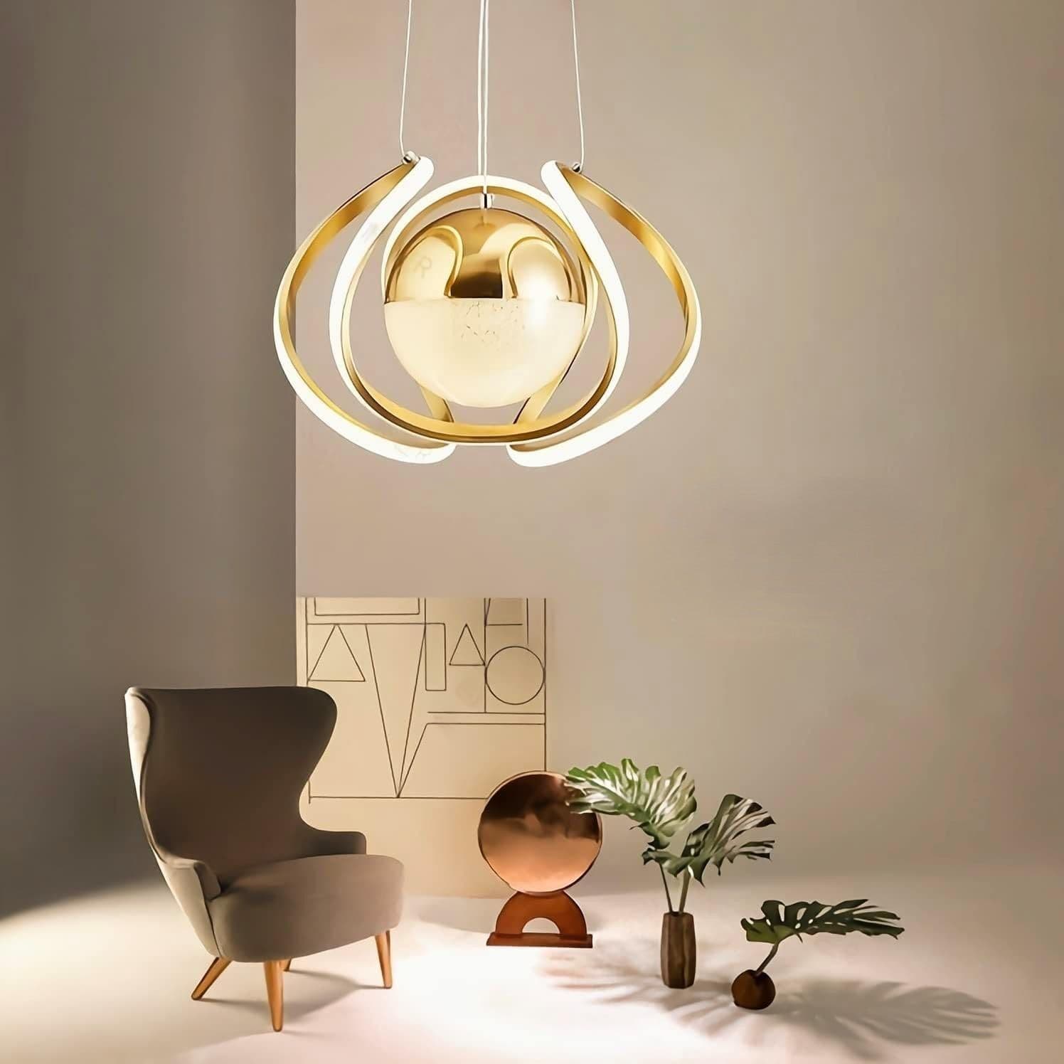 Gold LED chandelier lit warm, hanging above a chair in a living room