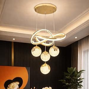 Gold spiral and ball chandelier lit warm against a ceiling
