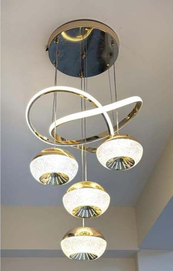 Modern gold LED chandelier with curved arms and round shades, on white background