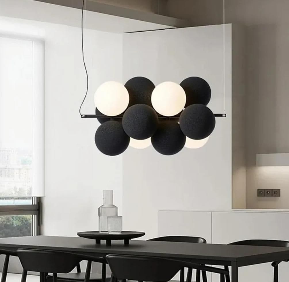 Velvet chandelier lit above a dining table