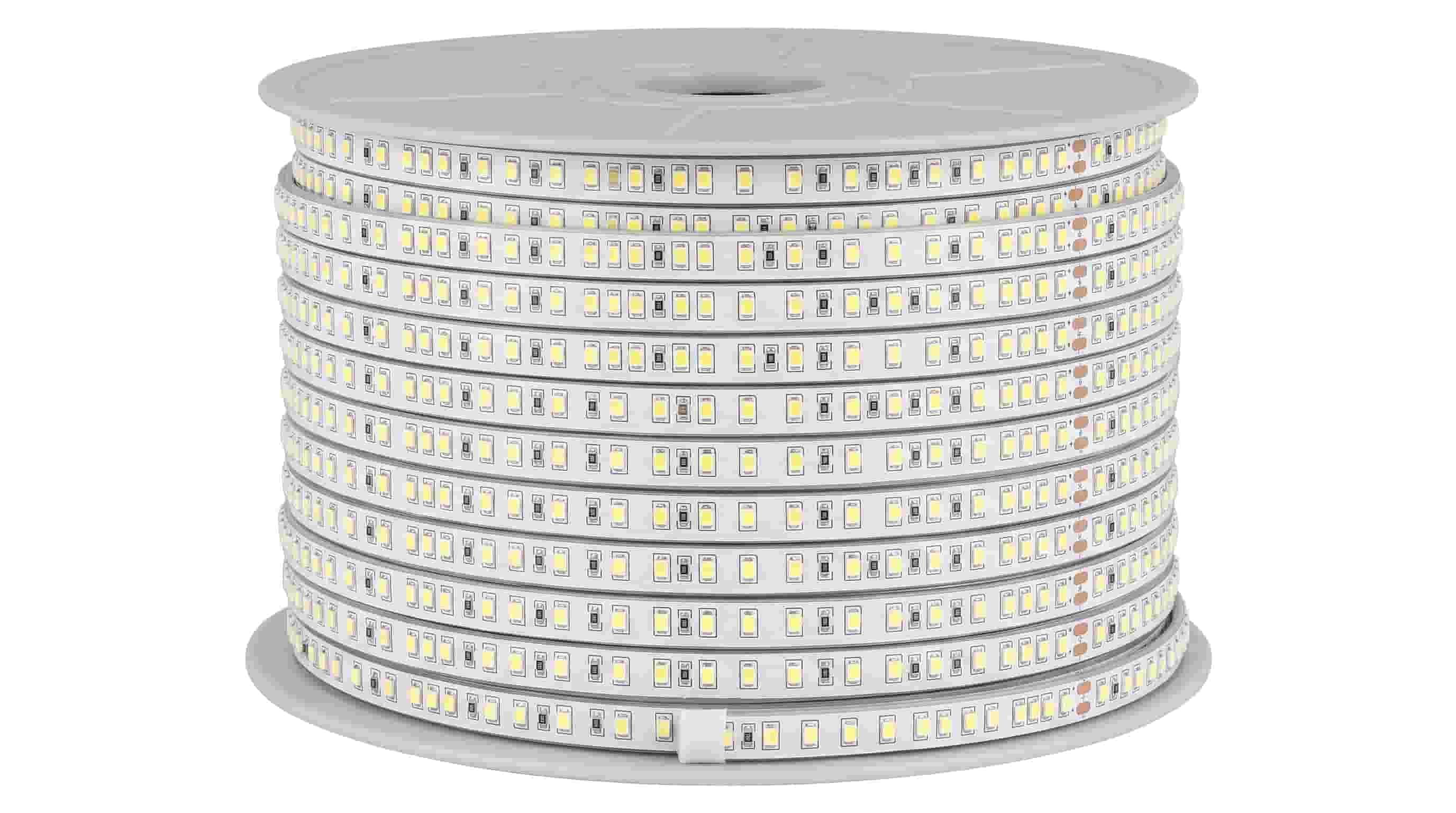 Coiled white LED strip light roll on plain background