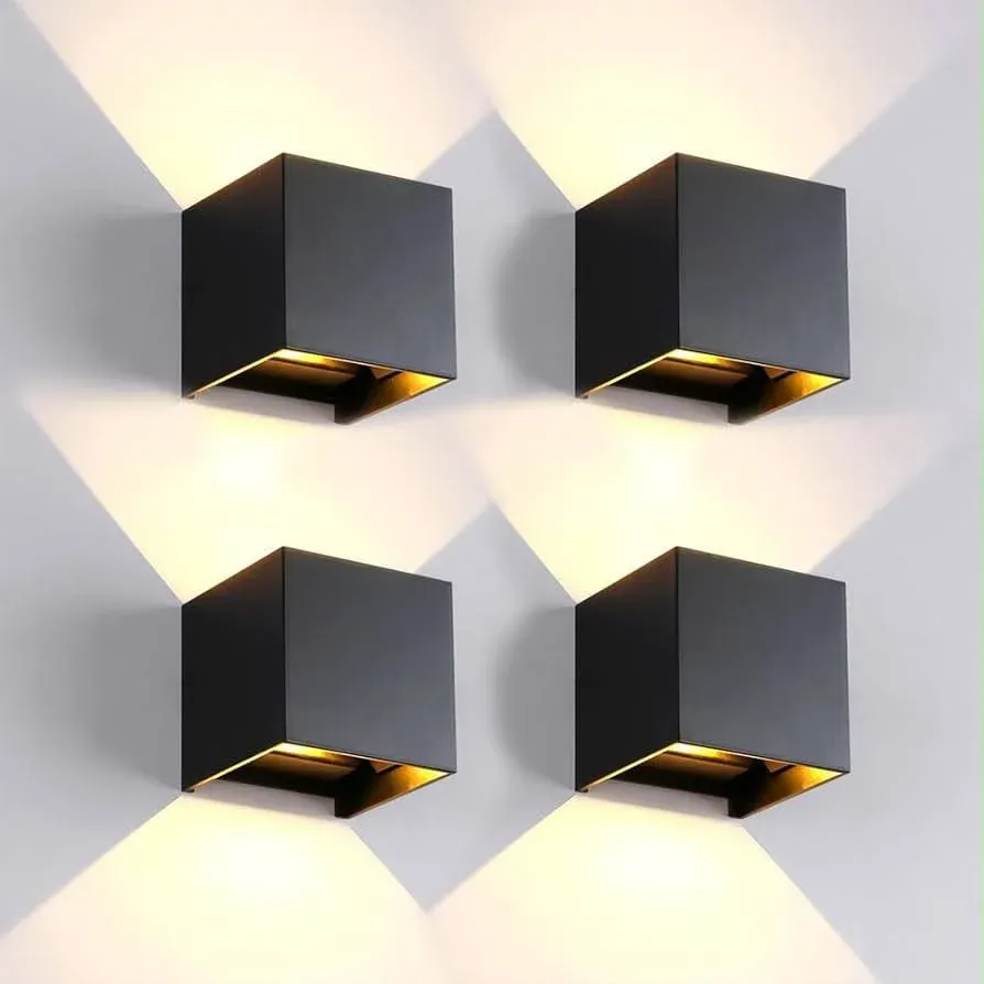 Four square LED wall lights installed in a grid pattern, lit