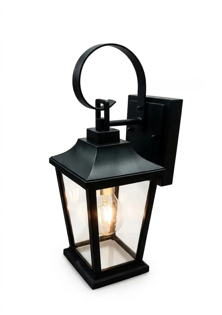 Outdoor wall lamp with clear glass panels, black lantern with curved bracket, on plain background