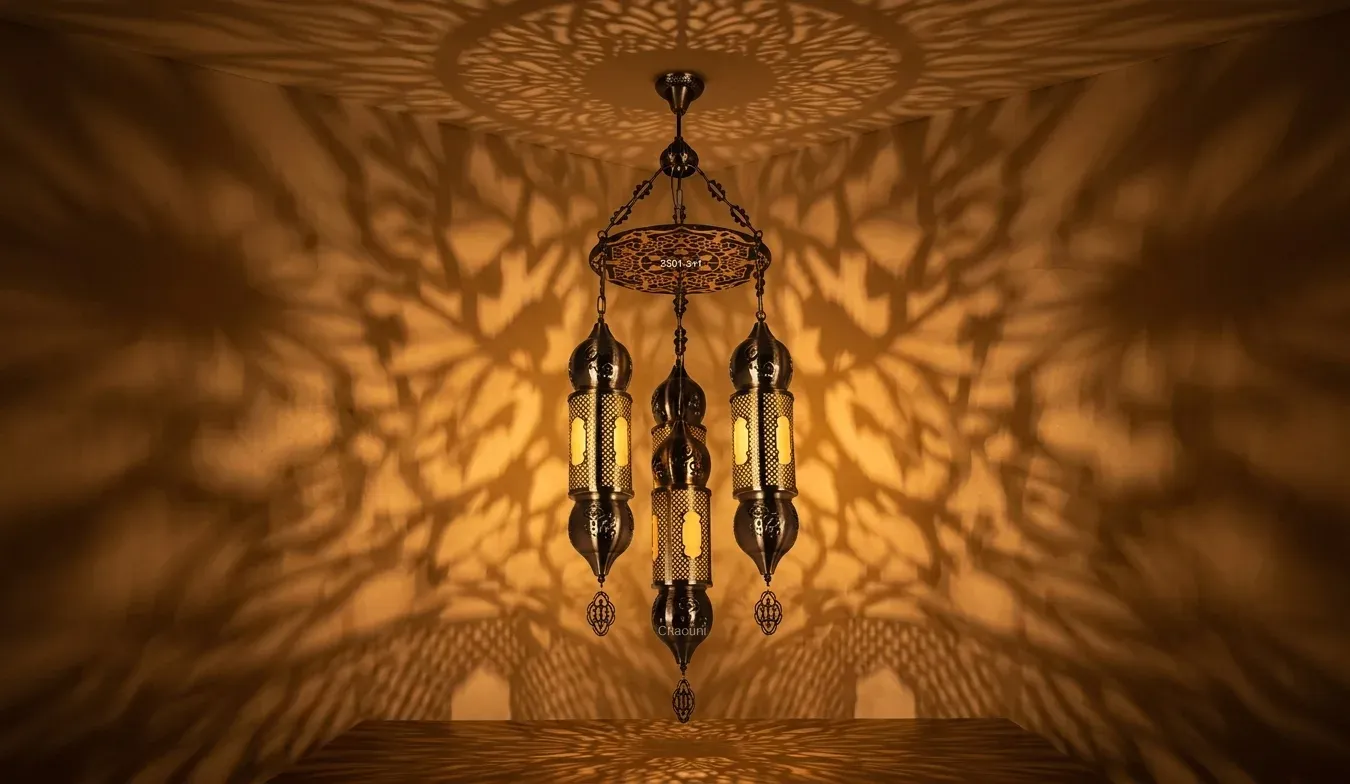 Three lantern Moroccan pendant chandelier lit, casting a decorative shadow pattern